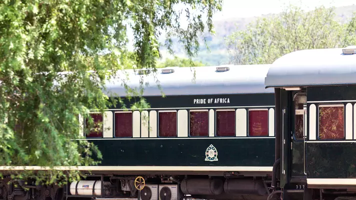 The exterior of a train carriage with the words "Pride of Africa" printed above the windows.
