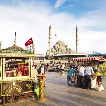 Food stalls on square beside Bosphorus with mosque in background.
Lonely Planet Traveller Magazine, acrosstheplanet, Extras