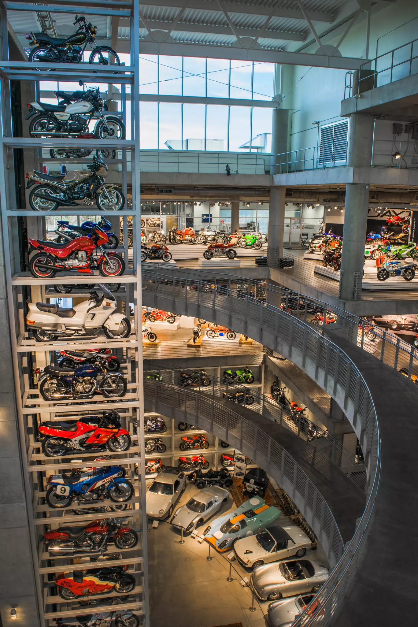 Vintage cars and motorcycles on display in a museum