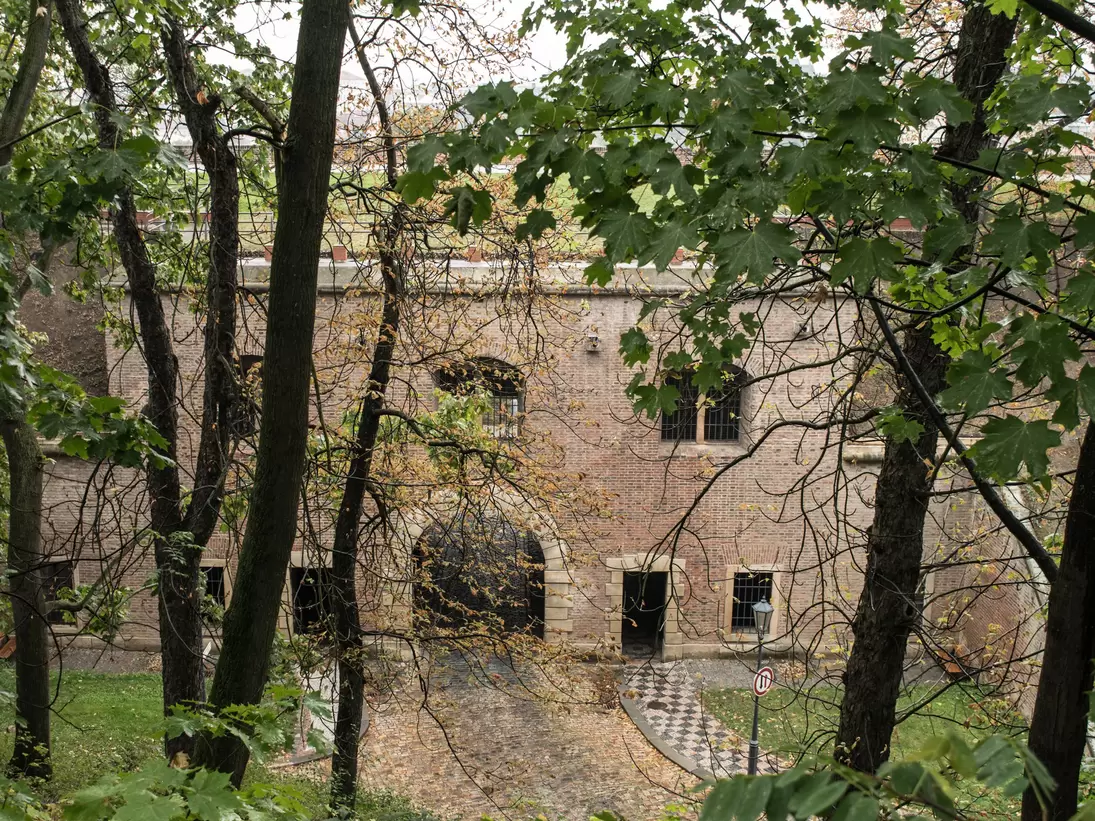 Prague, Czech Republic. Overhead view of the brick gate to the fortress Vysehrad with trees in the foreground.