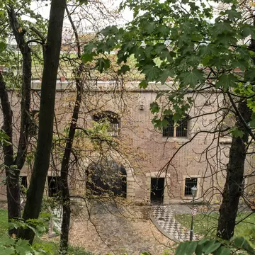 Prague, Czech Republic. Overhead view of the brick gate to the fortress Vysehrad with trees in the foreground.