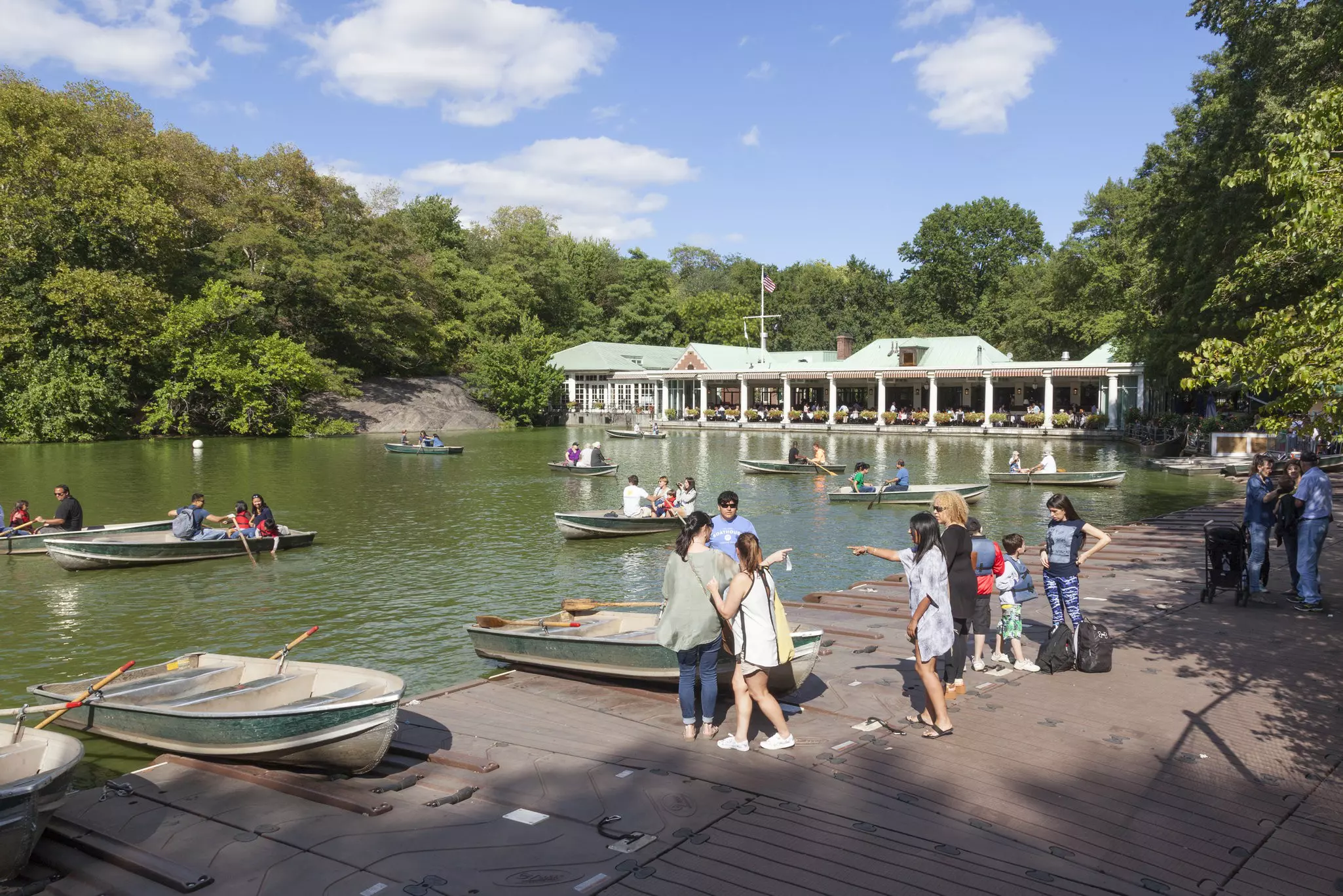 Visitors row in boats in a Central Park pond near the Central Park Boathouse.