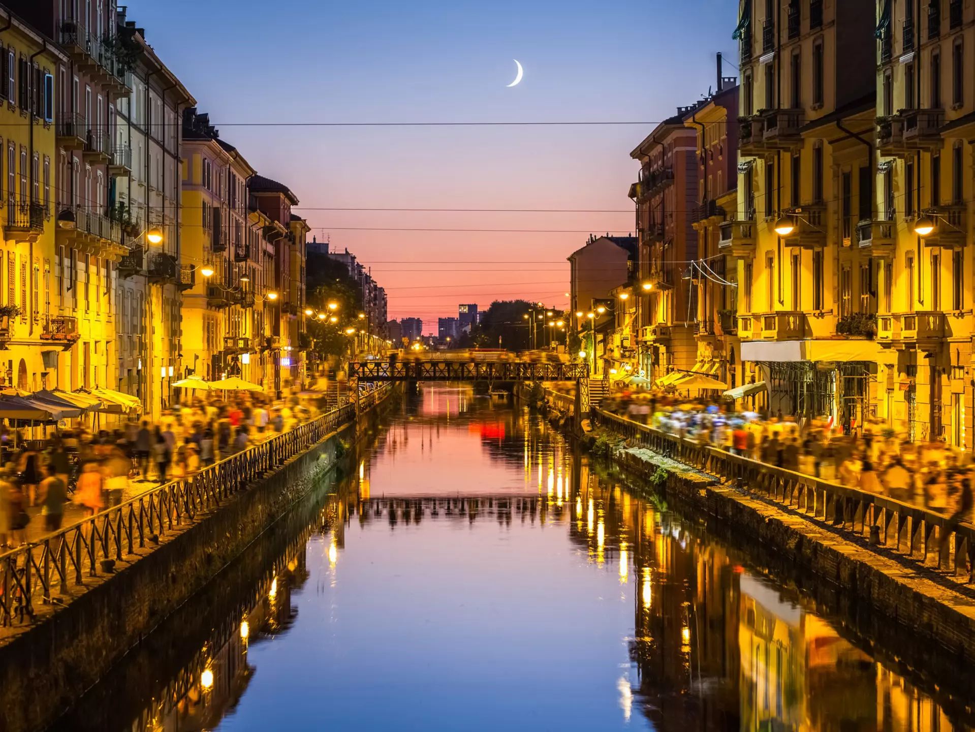 The Navigli district comes alive at night. deimagine / Getty Images