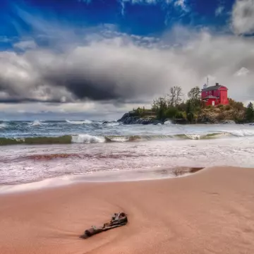 The Coast Guard Lower Harbor Lighthouse stands on an island just off the shores of Marquette, on Lake Superior. Marquette is a hub of adventure travel on Michigan's Upper Peninsula © bperucco / Getty Images
