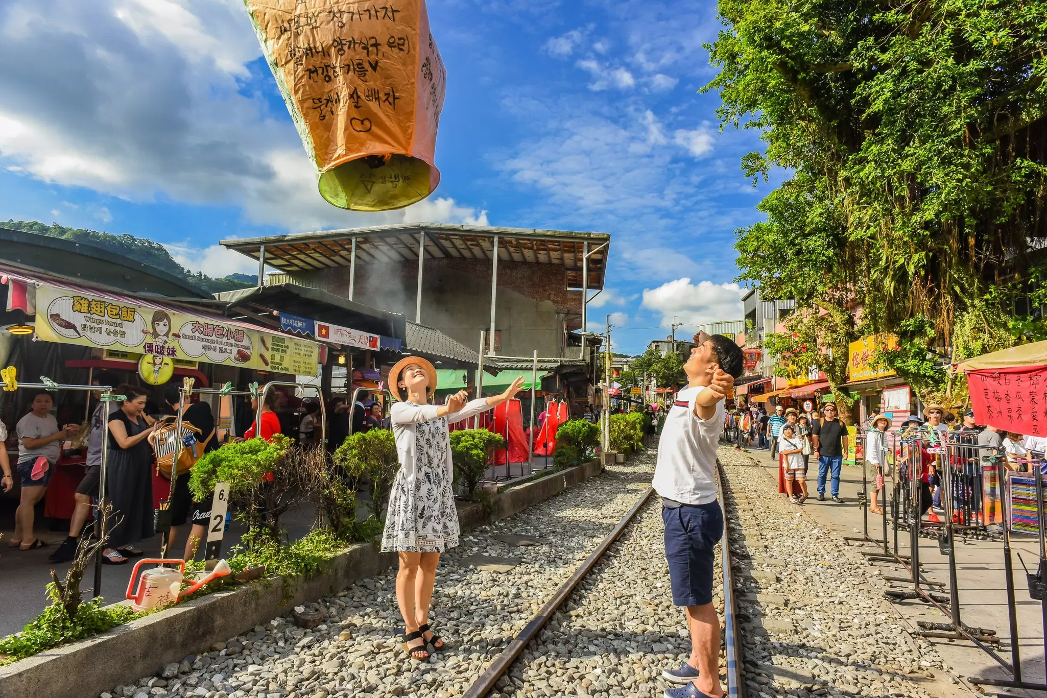 Tourists releasing sky lanterns along the Pingxi Railway line near Taipei, Taiwan