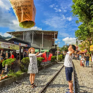 Tourists launching sky lanterns along the Pingxi Railway line near Taipei
676565620
activity, beauty, blue, calm, celebrate, celebration, chinese, countryside, culture, dream, festival, float, fly, hope, japanese, keelung, korean, lantern, launch, light, lucky, peace, peaceful, pingxi, popular, railway, red, rock, ruifang, shifen, sky, stone, taipei, taiwan, tourist, town, traditional, train, trip, village, wishes