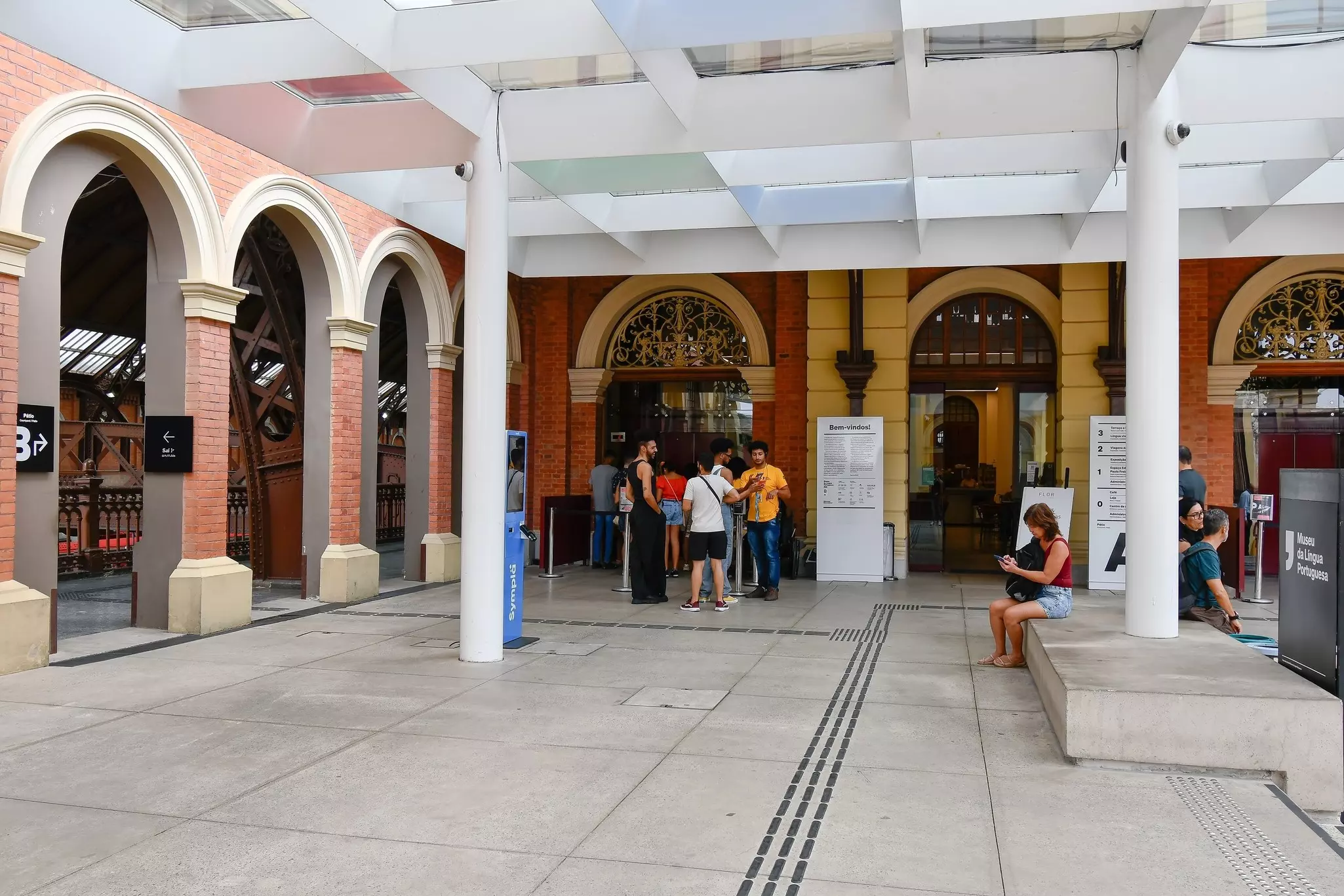 Two women sit outside the cafe in the sun