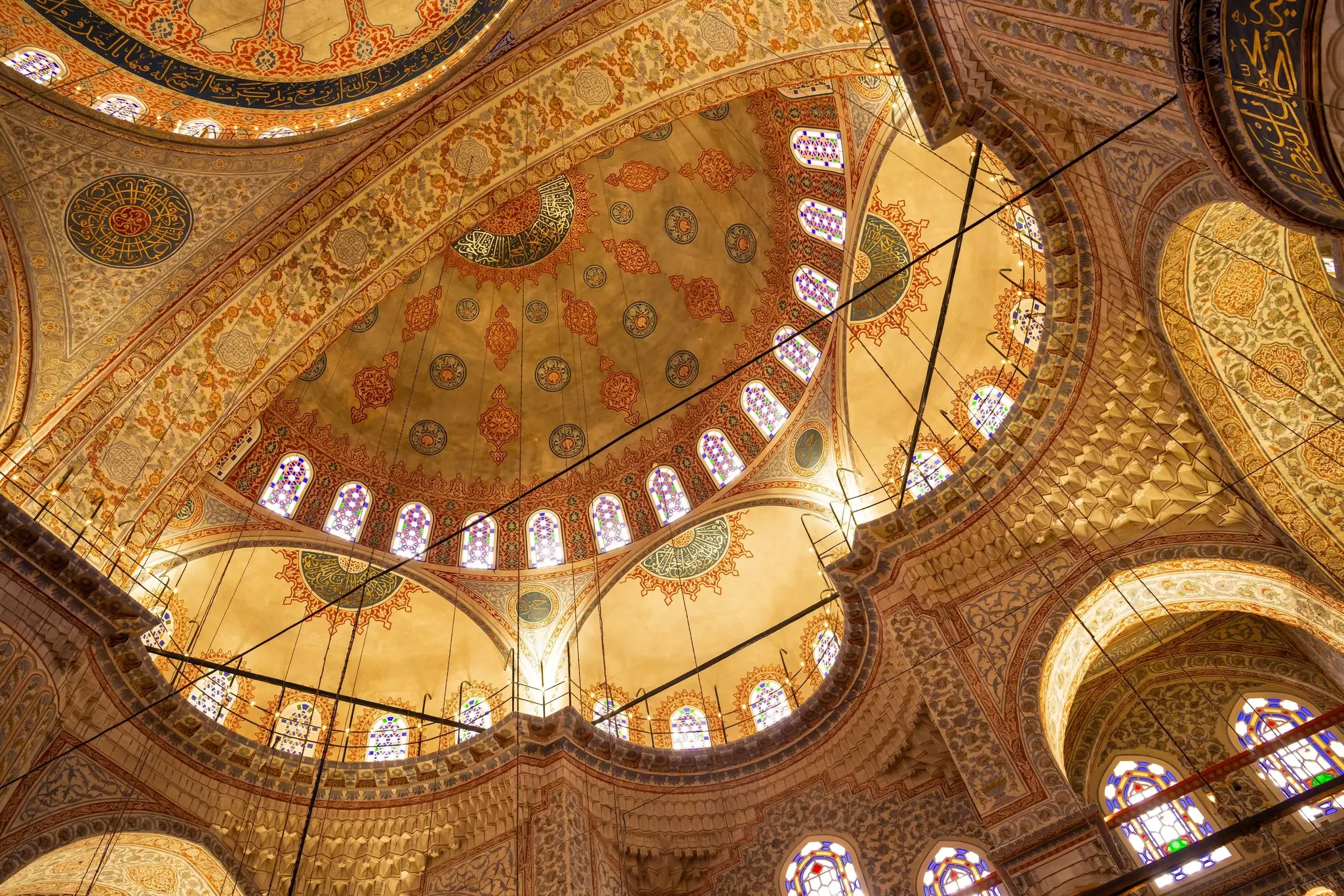 Elaborately tiled domes and arches at a mosque.