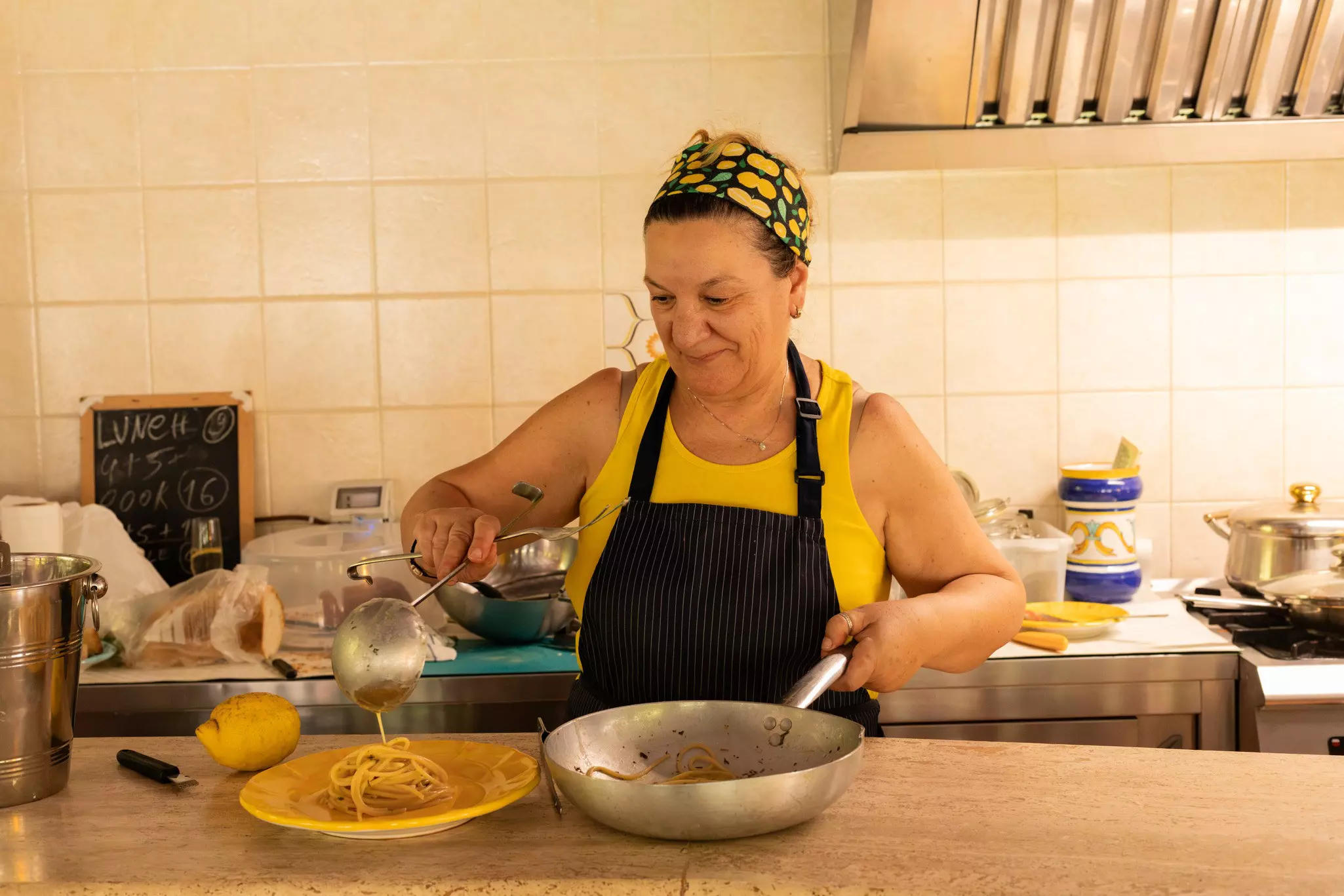 A woman is serving up pasta on the Honey Lemon Experience & Tour, Amalfi Coast Italy