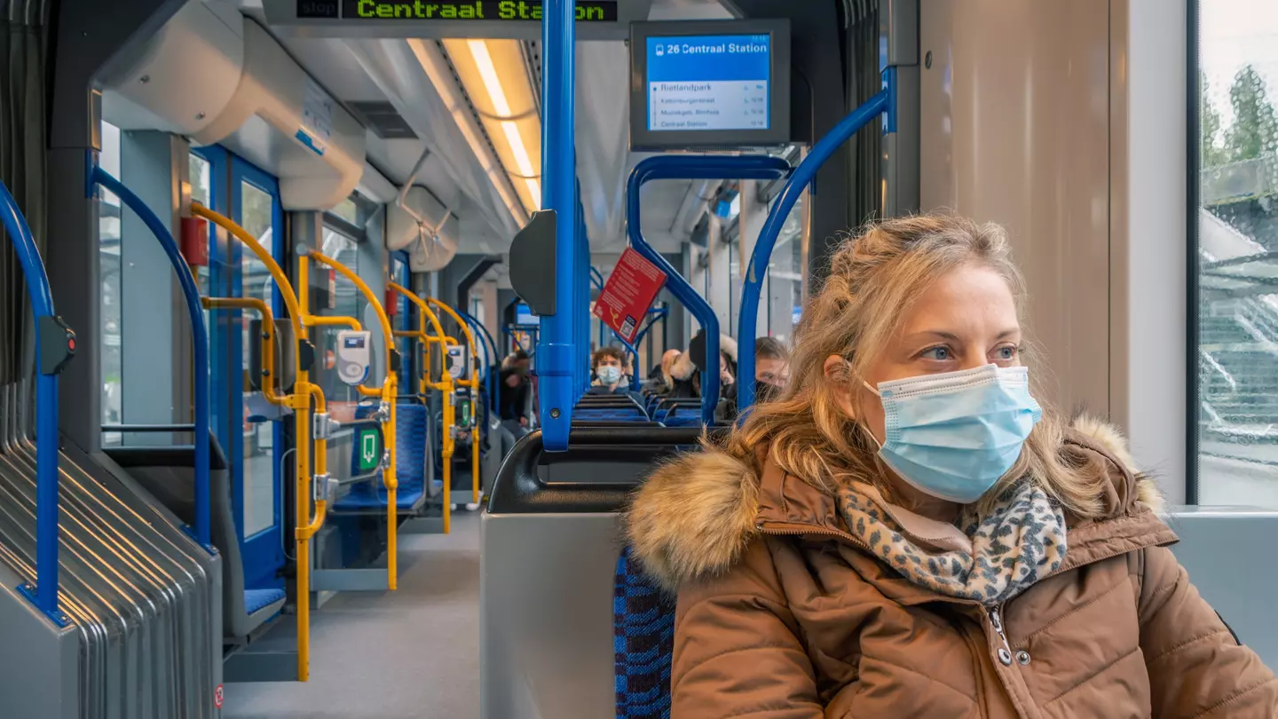 A woman with a facemask on public transportation