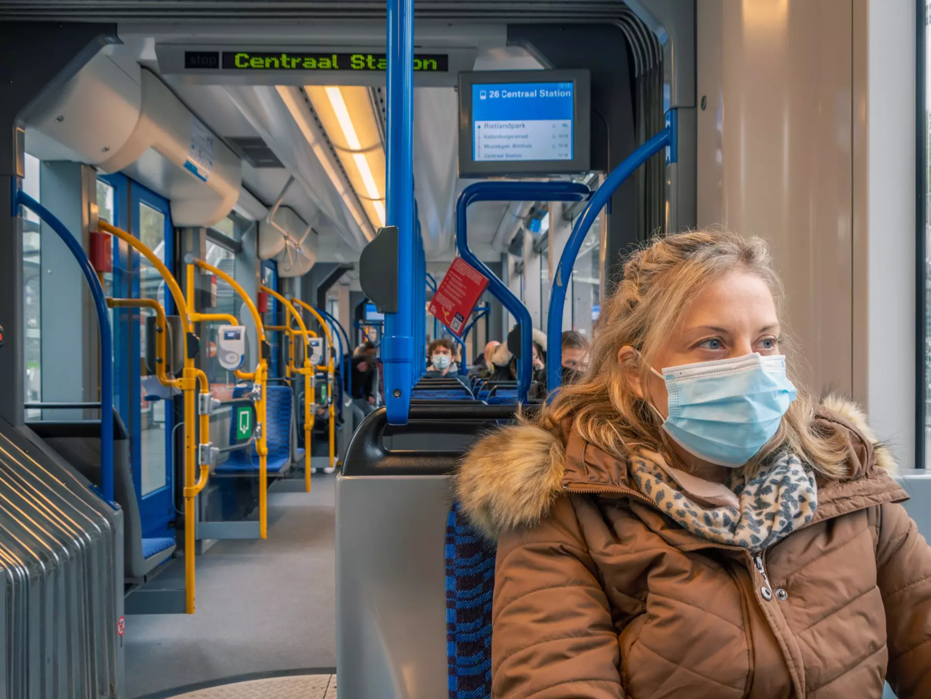 A woman with a facemask on public transportation