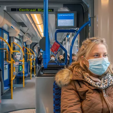A woman with a facemask on public transportation
