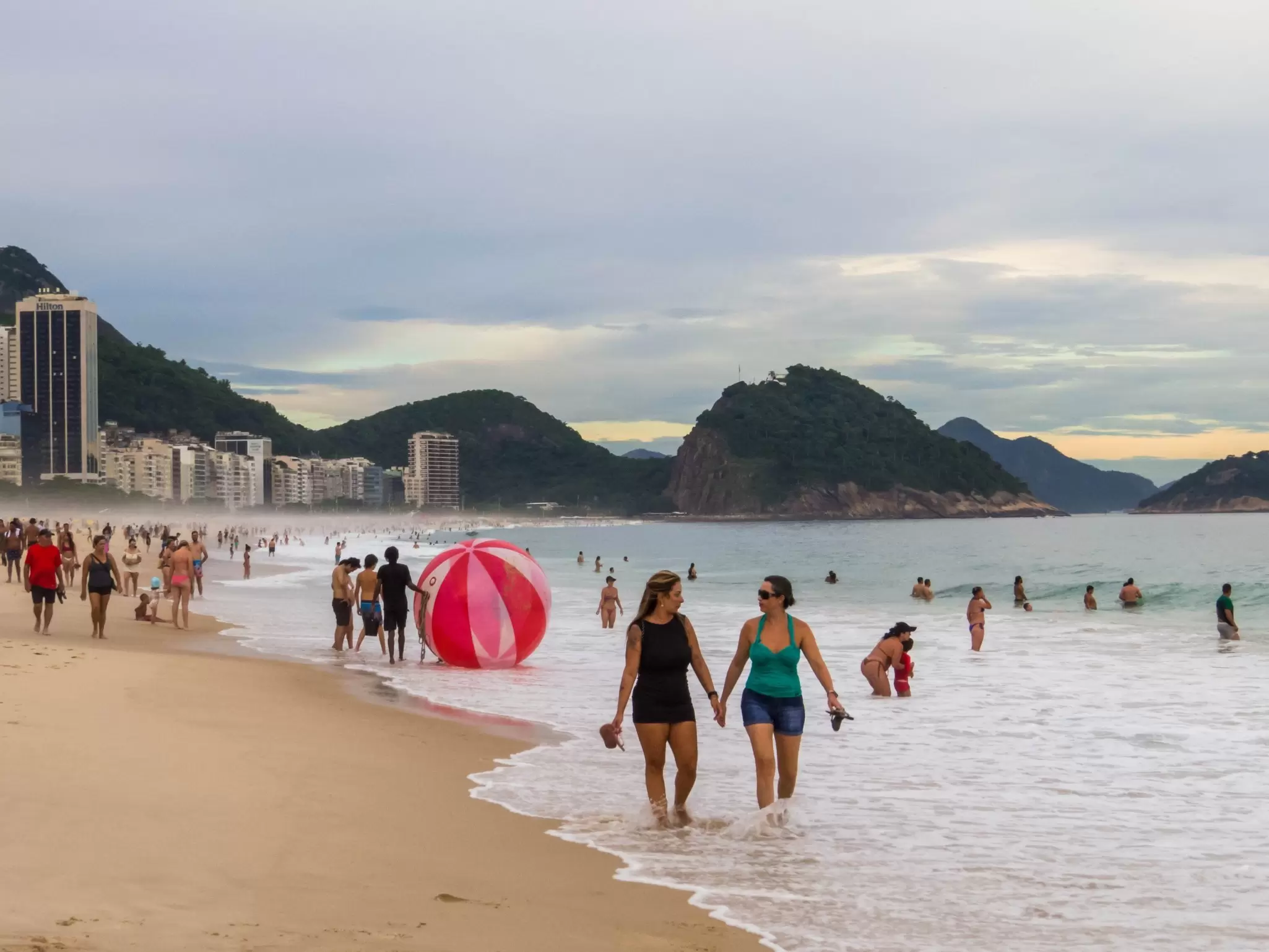 People walk on the famous beach of Copacabana in Rio de Janeiro, Brazil.