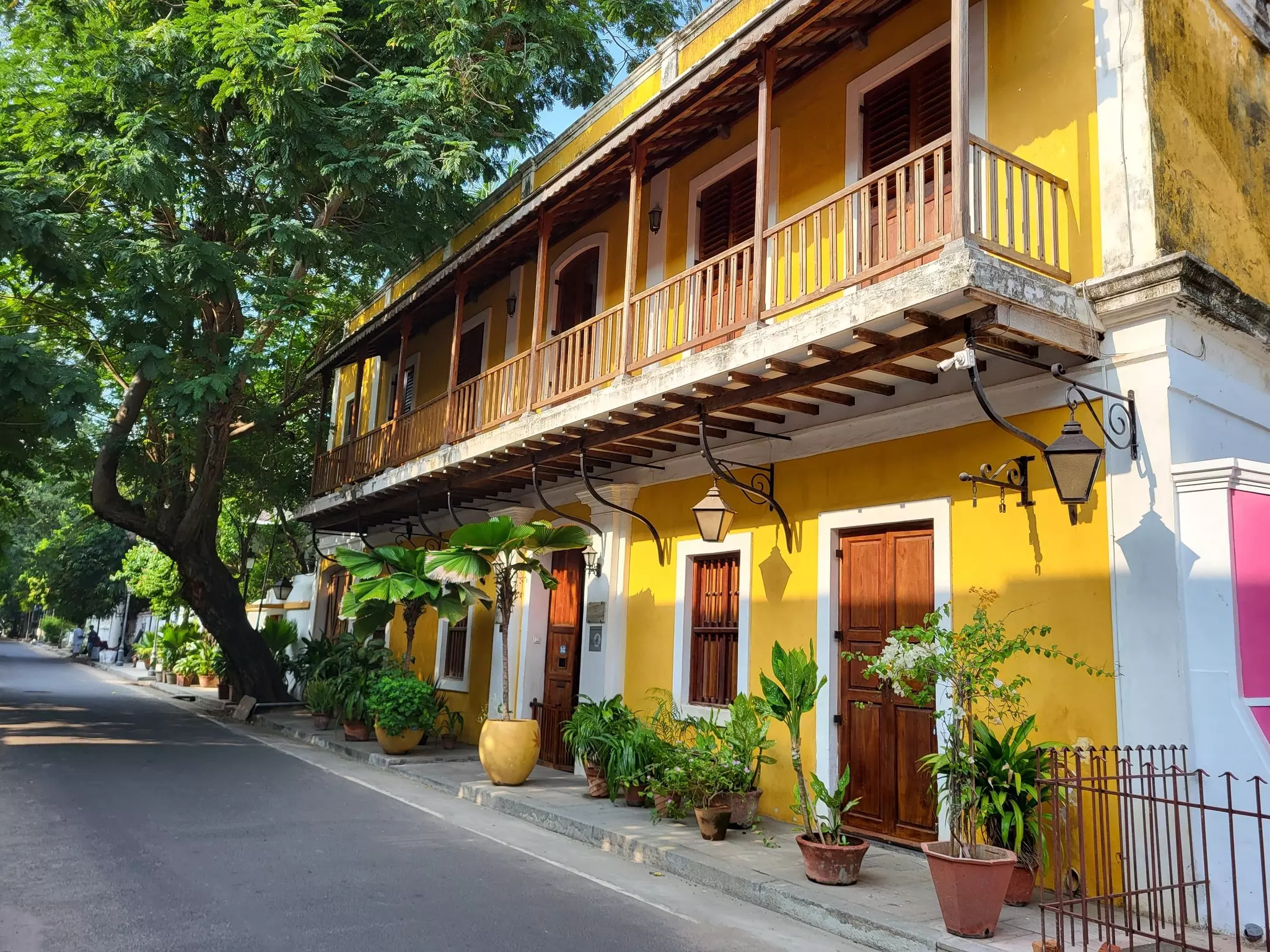 Yellow building with a wooden balcony on the upper level in Pondicherry, India