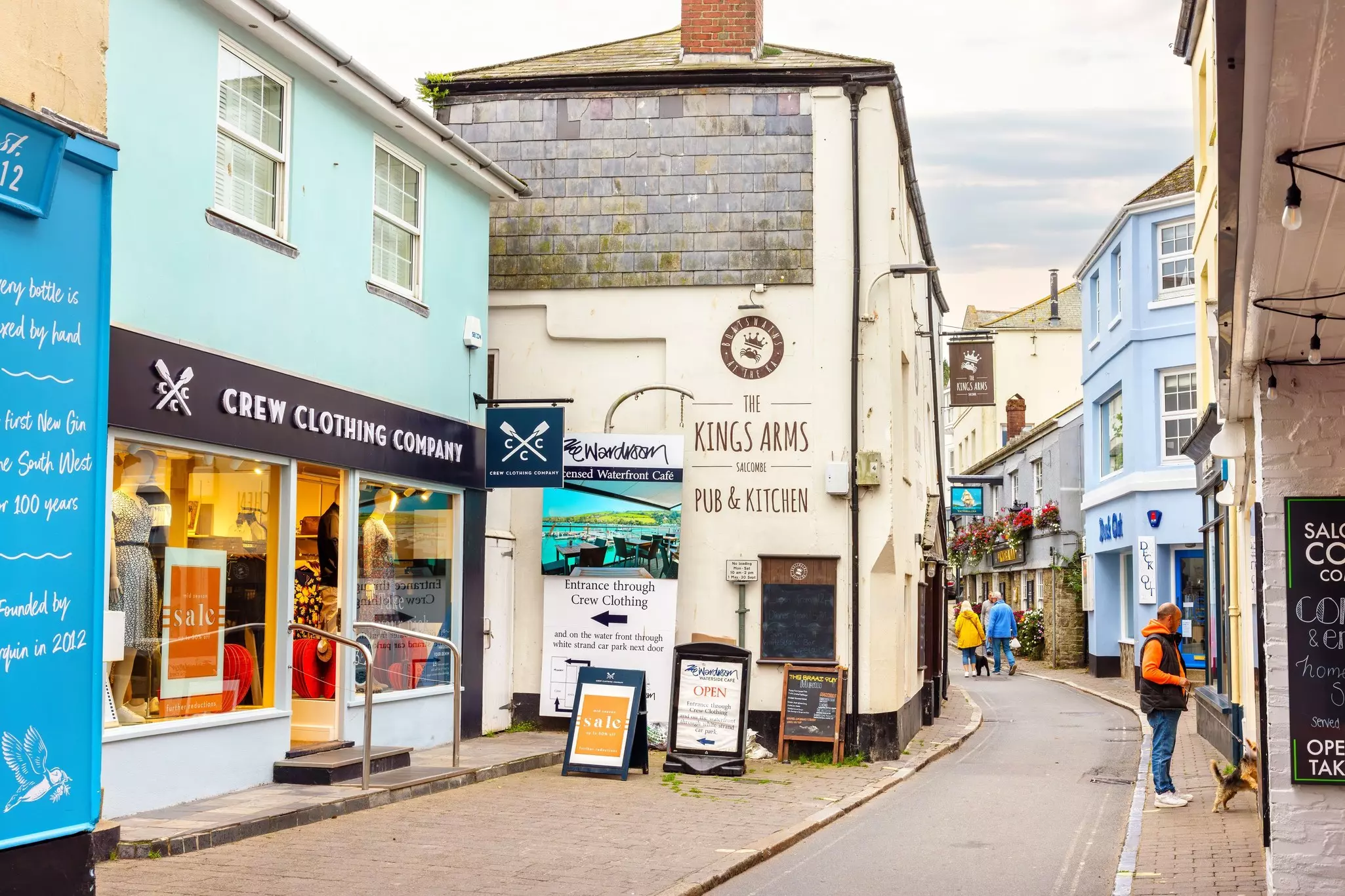 Salcombe, Devon, England - October 11, 2023: Tourists walking along the cozy Fore street in town centre