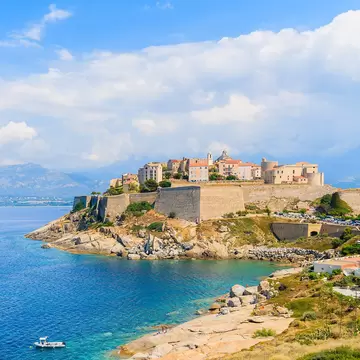 View of citadel with houses in Calvi bay, Corsica island, France.   