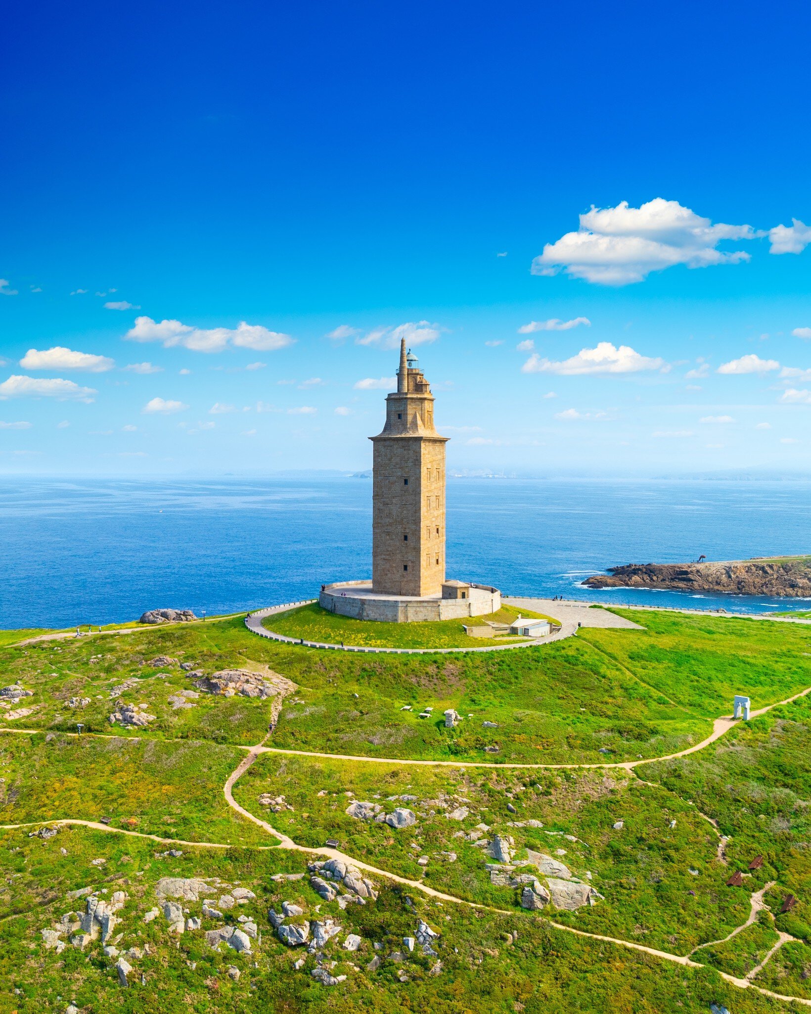 View of the Torre de Hércules on a sunny day in A Coruña, Spain, with the sea in the background.