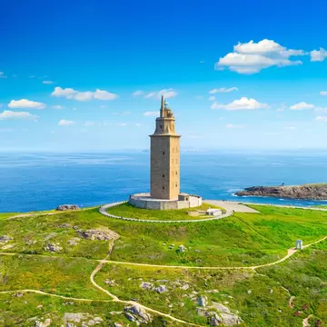 View of the Torre de Hércules on a sunny day in A Coruña, Spain, with the sea in the background.