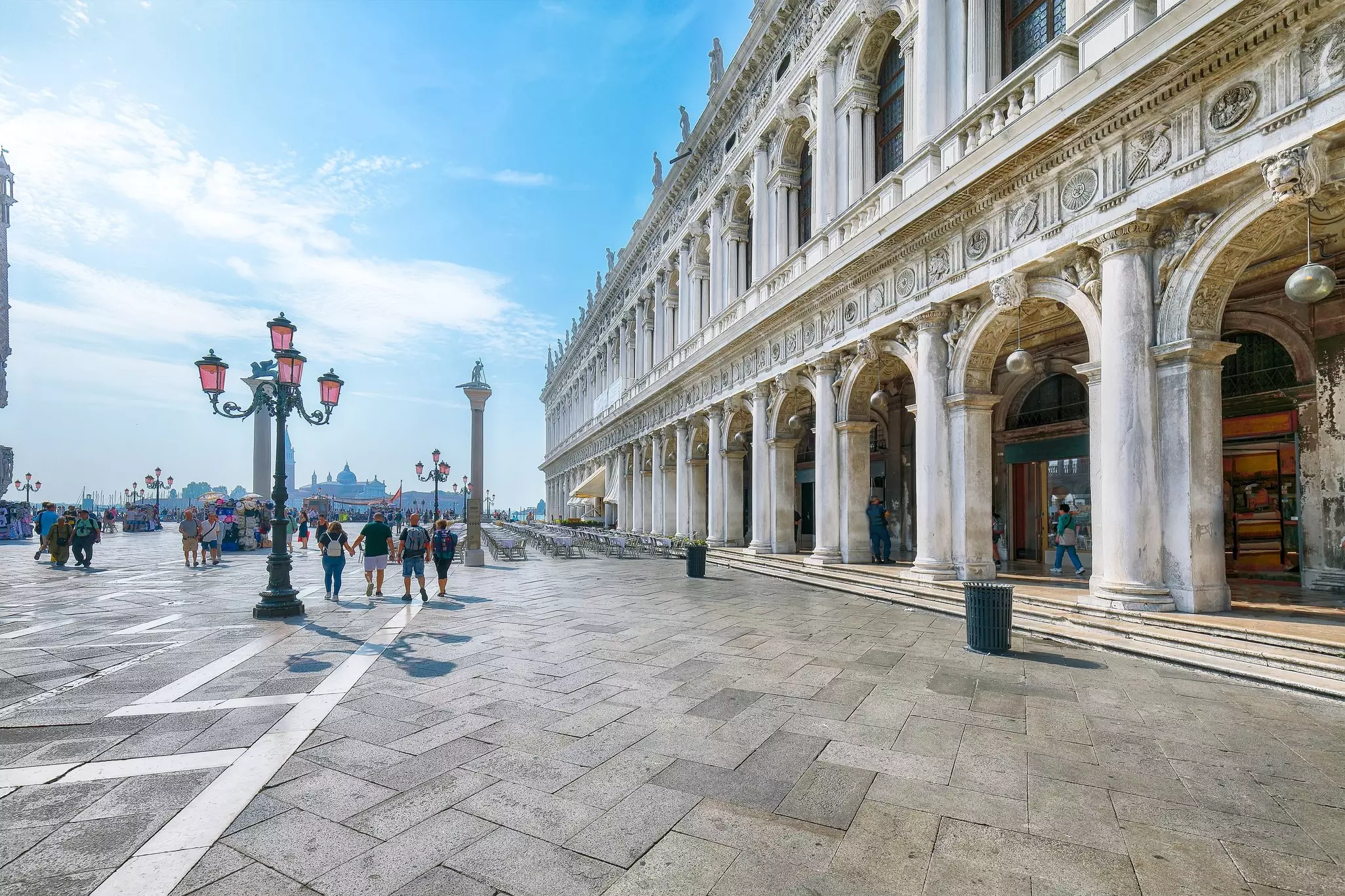 The ornate marble facade of a grand palatial building on a city square