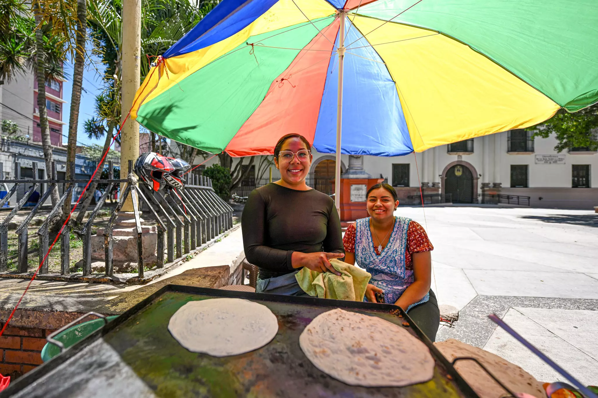 Two women prepare baleadas, typical Honduran food, on a street in Tegucigalpa, Honduras n March 26, 2023. (Photo by Xin Yuewei/Xinhua via Getty Images)