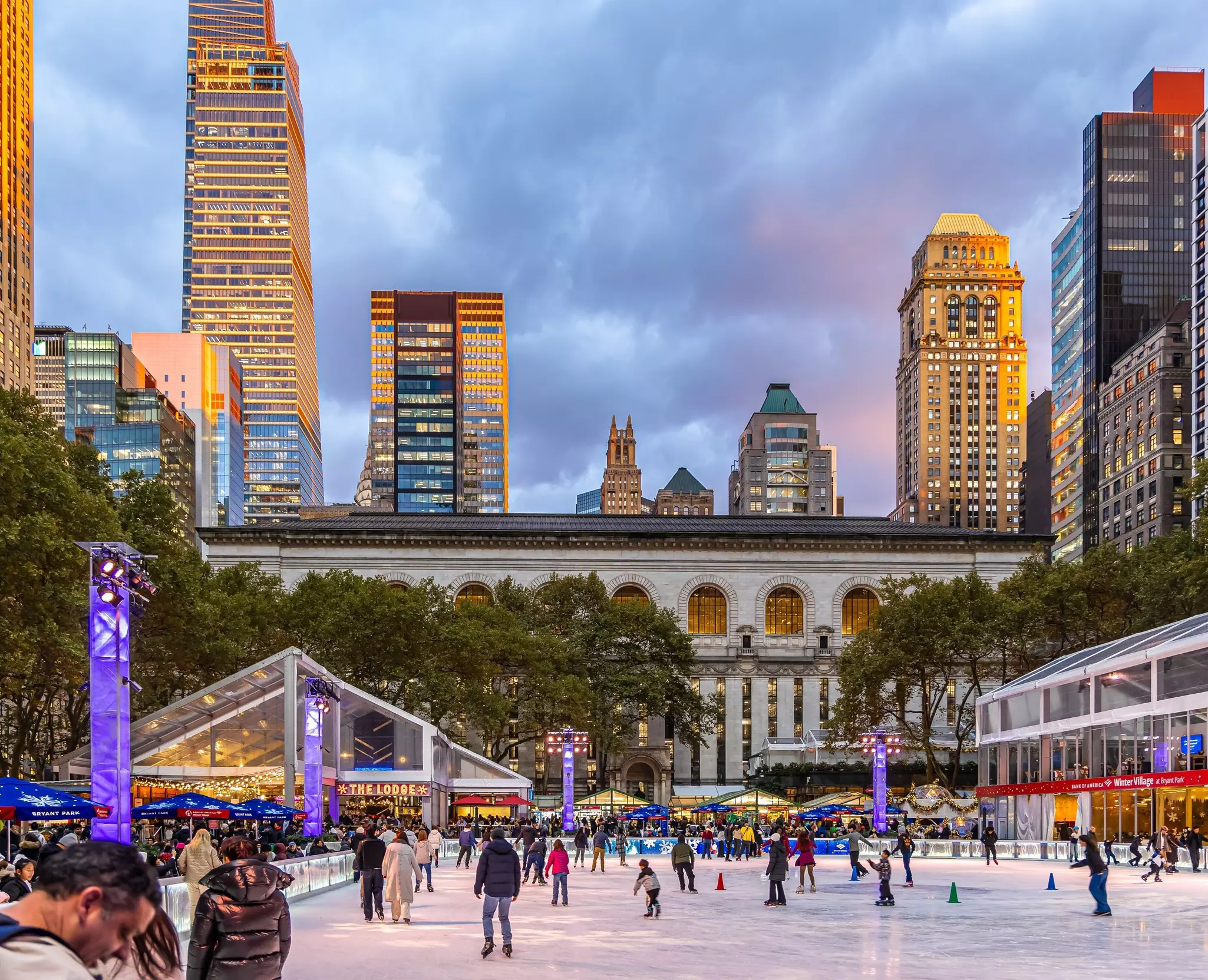 New York, US - 14 Nov 2025: Winter holiday market and ice skating rink at Bryant Park with Midtown Manhattan skyline at sunset. Popular seasonal attraction in New York City, License Type: media, Download Time: 2025-12-04T21:42:41.000Z, User: rhylton_redventures, Editorial: true, purchase_order: 65050 - Digital Destinations and Articles, job: Lonely Planet, client: social, other: Rhianydd Hylton