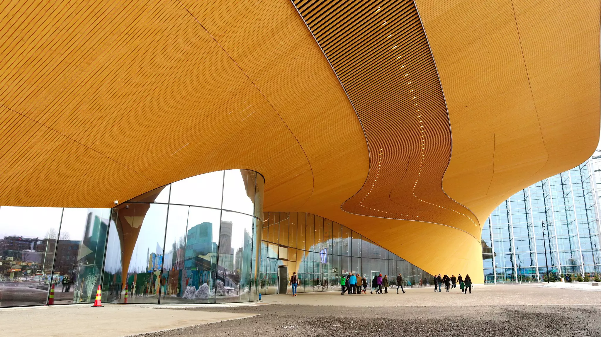 The sweeping overhang of the central library in Helsinki, Finland, shelters people on the plaza below.
