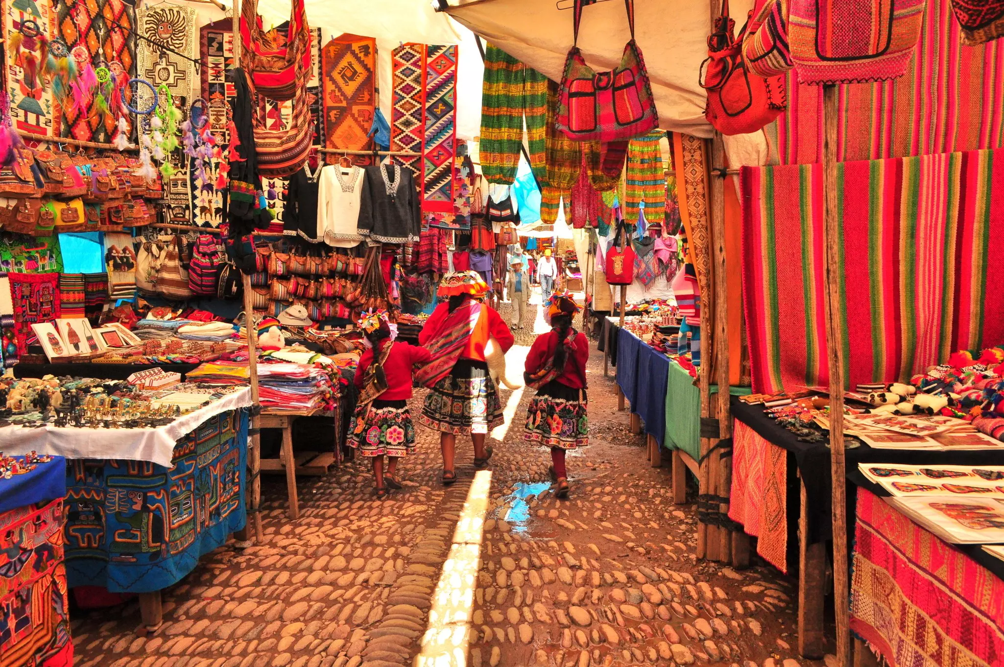 A Peruvian family shops in a local market in Pisac, a tiny town that has fully embraced its new-age culture © Julieta Gonzalez Checchin / Shutterstock