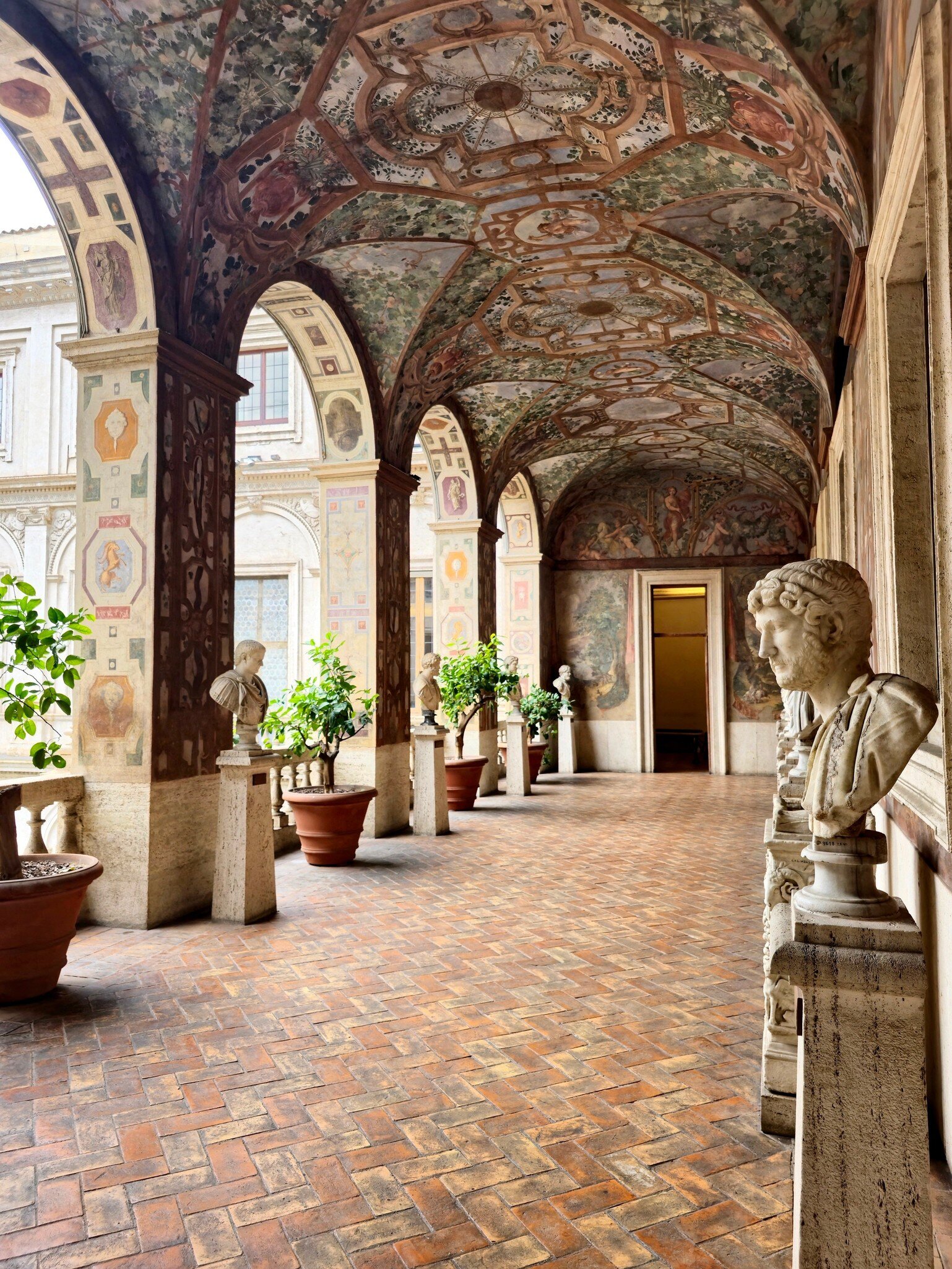 View of a frescoed corridor adorned with marble busts in the Palazzo Altemps at the Museo Nazionale Romano in Rome, Italy.