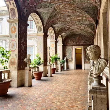 View of a frescoed corridor adorned with marble busts in the Palazzo Altemps at the Museo Nazionale Romano in Rome, Italy.
