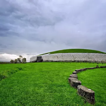 Newgrange Megalithic Passage Tomb with gray skies above