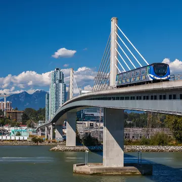 VANCOUVER, CANADA - AUGUST 11, 2016: Canada  Line train passes bridge on August 11, 2016. The Canada Line is Vancouver's new rapid transit rail link connecting airport to downtown Vancouver., License Type: media, Download Time: 2025-12-02T17:28:21.000Z, User: mvm_lonelyplanet, Editorial: true, purchase_order: 56530 - Guidebooks, job: Experience Canada 1, client: Global Publishing-WIP, other: Virginia Moreno