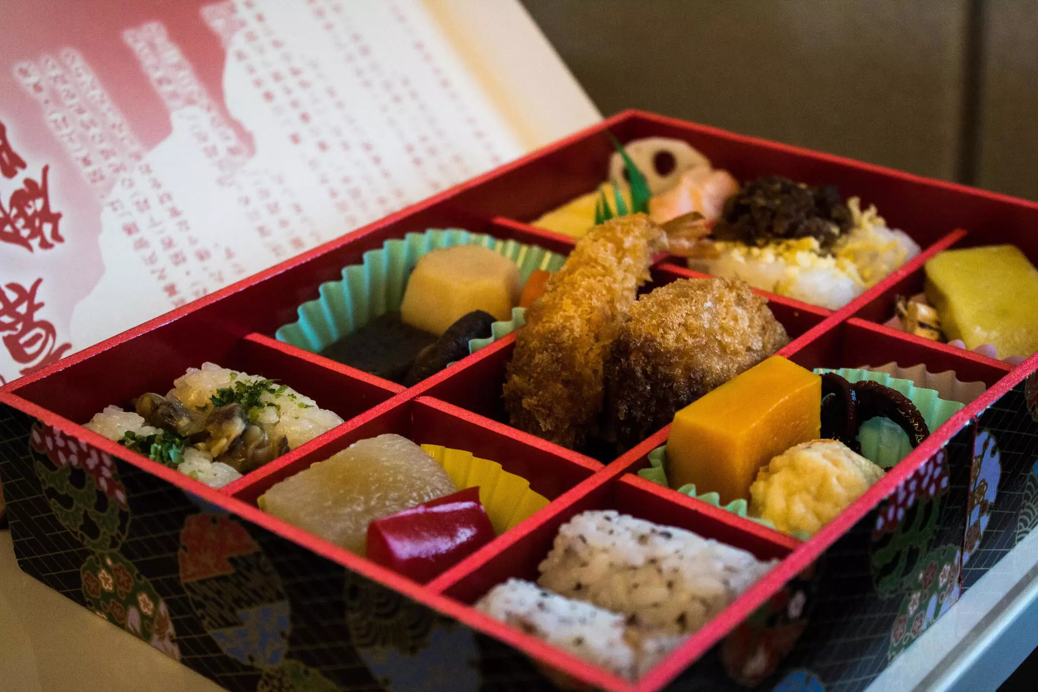 A beautifully presented bento box of food with each element separated into its own square in Japan.