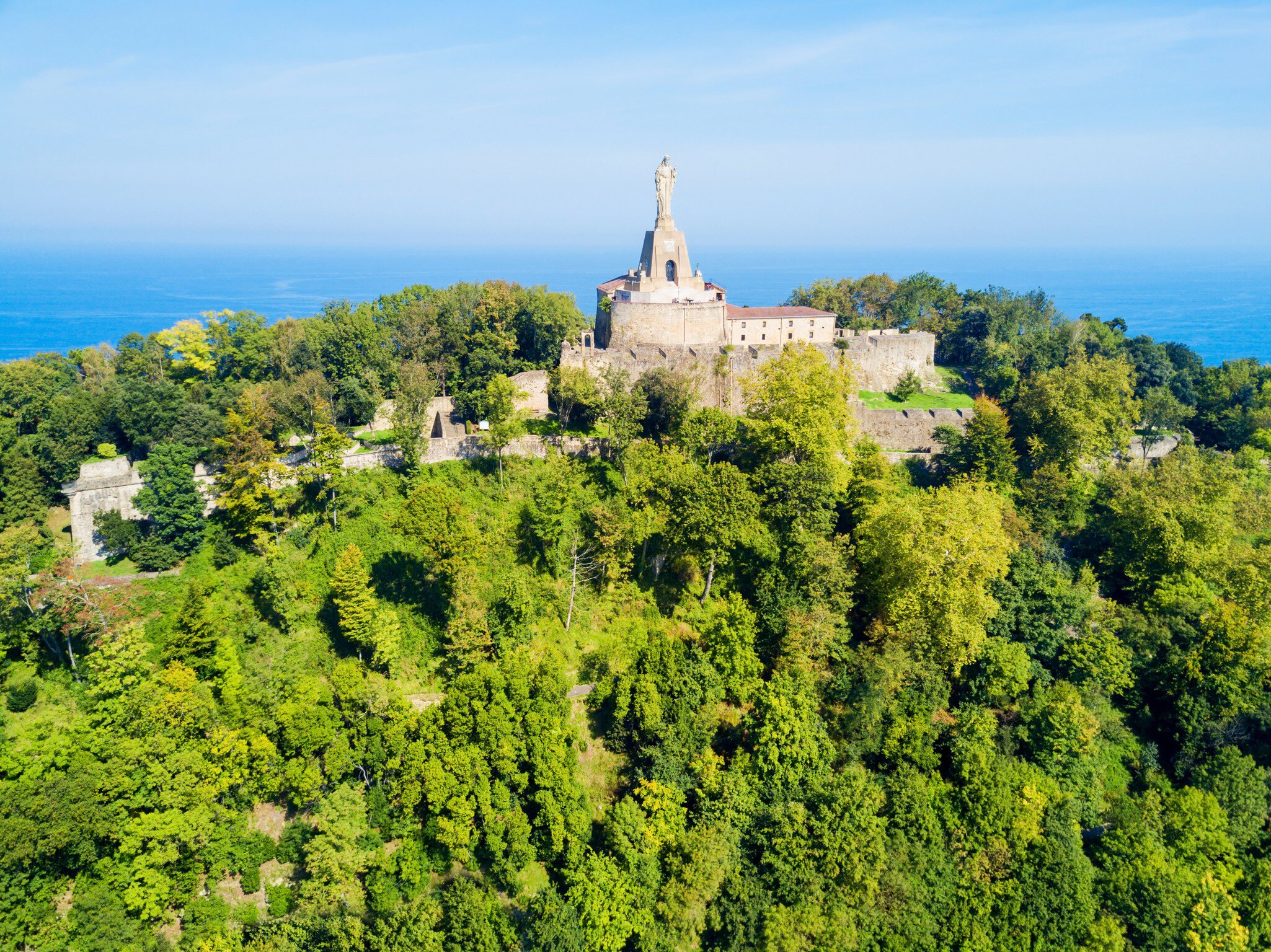 Aerial view of the statue on Monte Urgull on a sunny day in San Sebastián, Spain.