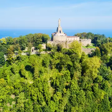Aerial view of the statue on Monte Urgull on a sunny day in San Sebastián, Spain.