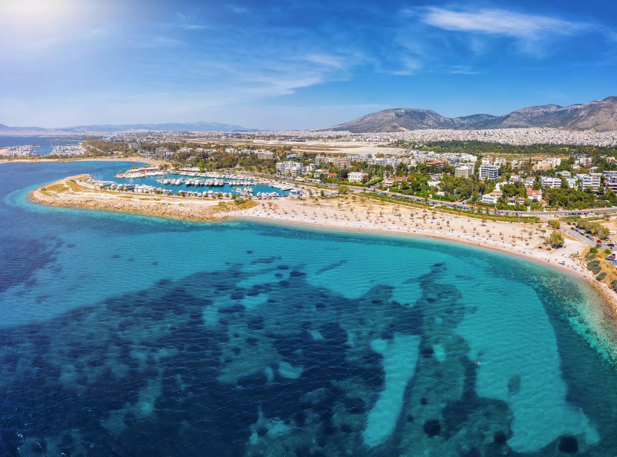 Aerial view of a beach with yacht marinas and a turquoise sea