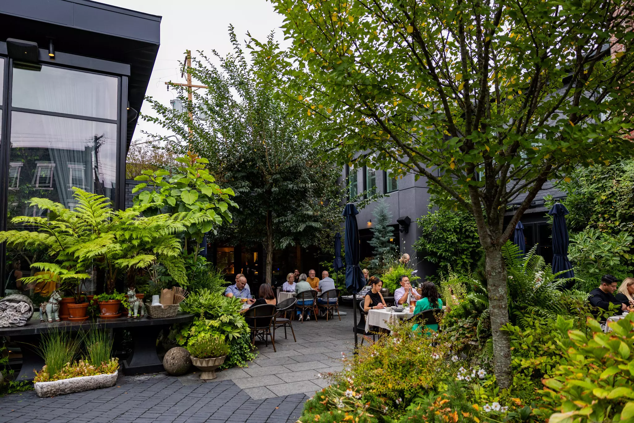 The shaded patio at a restaurant in Pittsburgh, with plenty of trees and diners