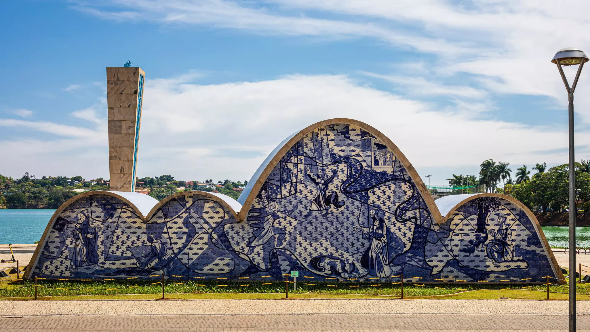 An unusually designed church with an undulating roof. Paintings in shades of blue adorn its entire facade