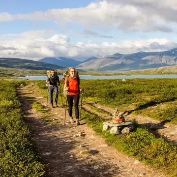 Couple hiking in Swedish north going for the hut.  Side light makes this photo warmer, License Type: media, Download Time: 2025-02-07T08:35:23.000Z, User: pinkjozie64, Editorial: false, purchase_order: 56530 - Guidebooks, job: Global Publishing WIP (for books) , client: Sweden 9, other: Jo-anne Riddell