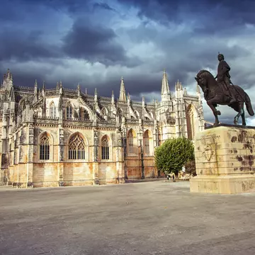 Monastery of Batalha (Monastery of Saint Mary of the Victory) and statue of Nuno Alvares Pereira.