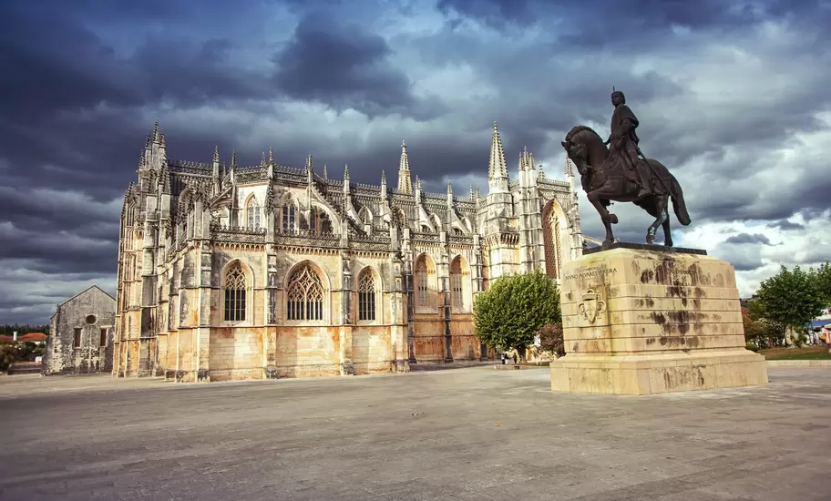 Monastery of Batalha (Monastery of Saint Mary of the Victory) and statue of Nuno Alvares Pereira.