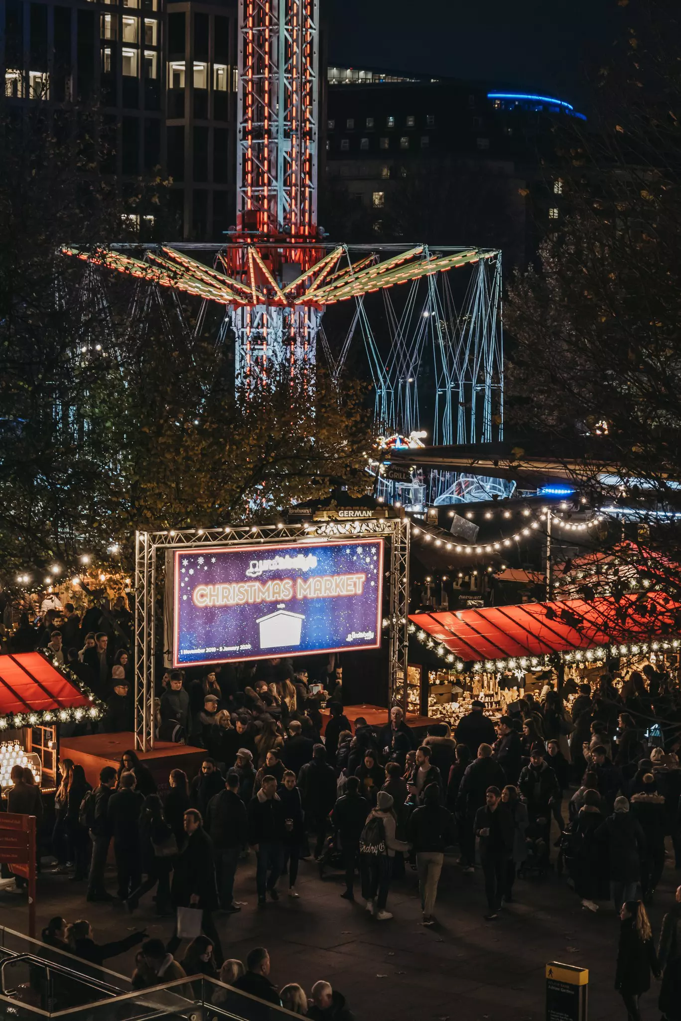 High angle view of people in Southbank Centre Winter Market, an outdoor, global street food market, focused on sustainable and artisan produce.,