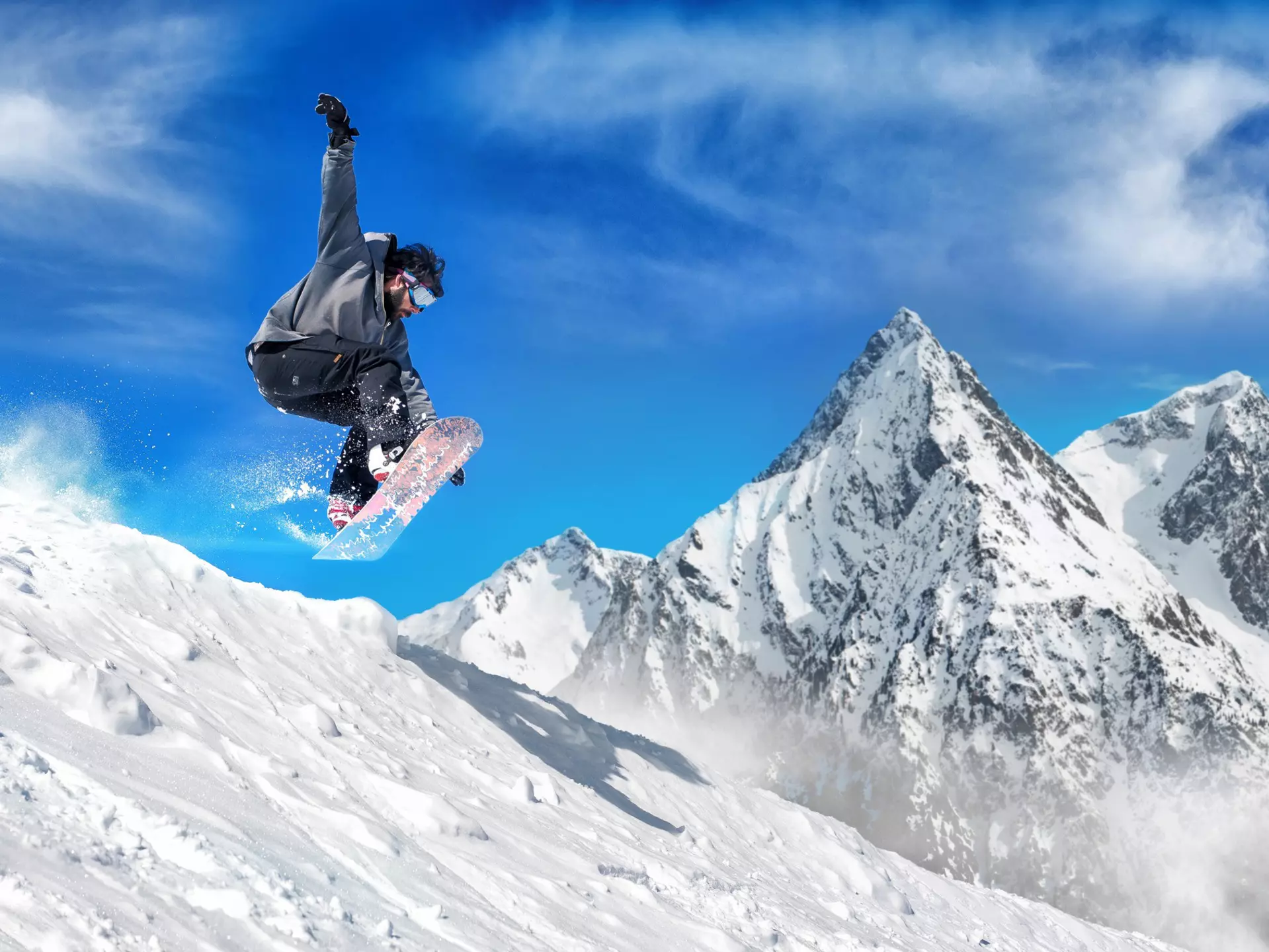 Snowboarder jumping high in the air with snow-capped mountains in the background. 
503871626
Speed, Sport, Relaxation, Competition, Comfortable, Ski Slope, Ski Goggles, Glacier, Happiness, Mountain, Skiing, Zero Gravity, High Up, Snowboarding, Comfort, Snowboard Cross, Extreme Sports, Winter, Glacier Vodka, Stunt, Alpine Skiing, Tourist Resort, Mountain Range, European Alps, Joy, Les Deux Alpes, Flying, Snow, Ski Pole, Horizontal, Reaching, Balance, Male, Jumping, Competitive Sport, Half Pipe, snow ski, Ice, Mid-Air, Smiling, Jump, Exhilaration, Powder Snow, Vacations, Sky, Nature, France, Rocky Mountains - North America, Directly Below, Males, 60161, Europe, Photography, Sunglasses, Snowboard, Outdoors, 258742
