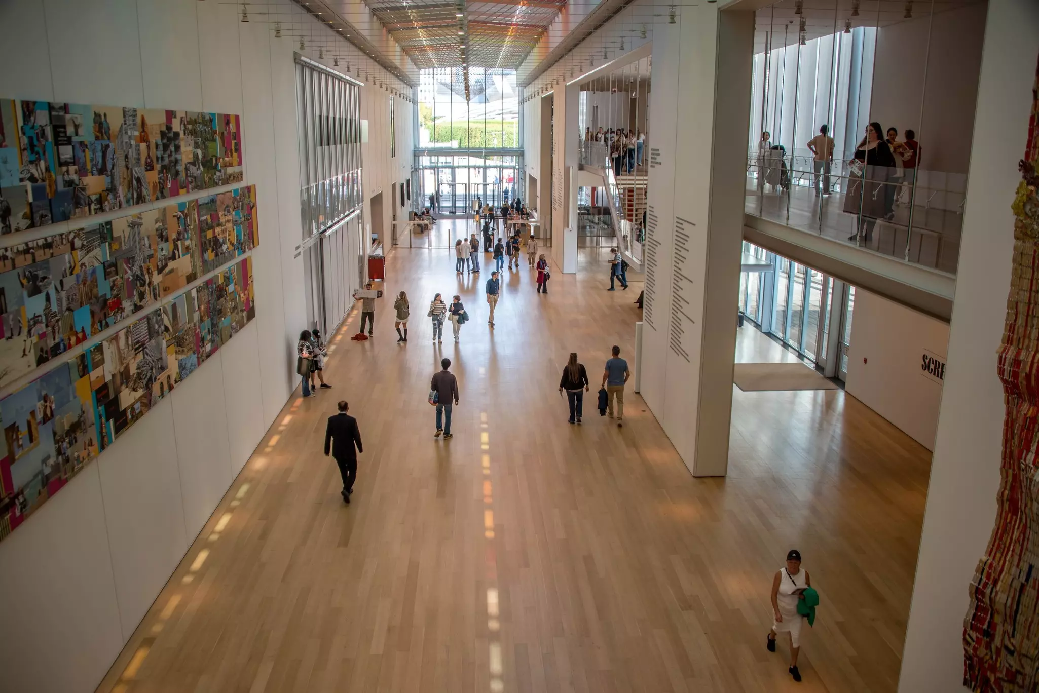 People walking in a wing of an art museum