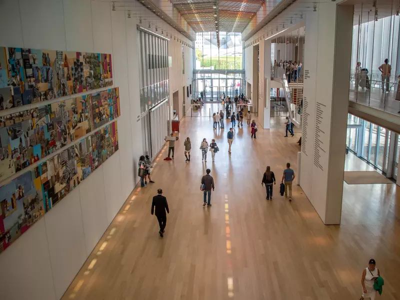 People walking in a wing of an art museum