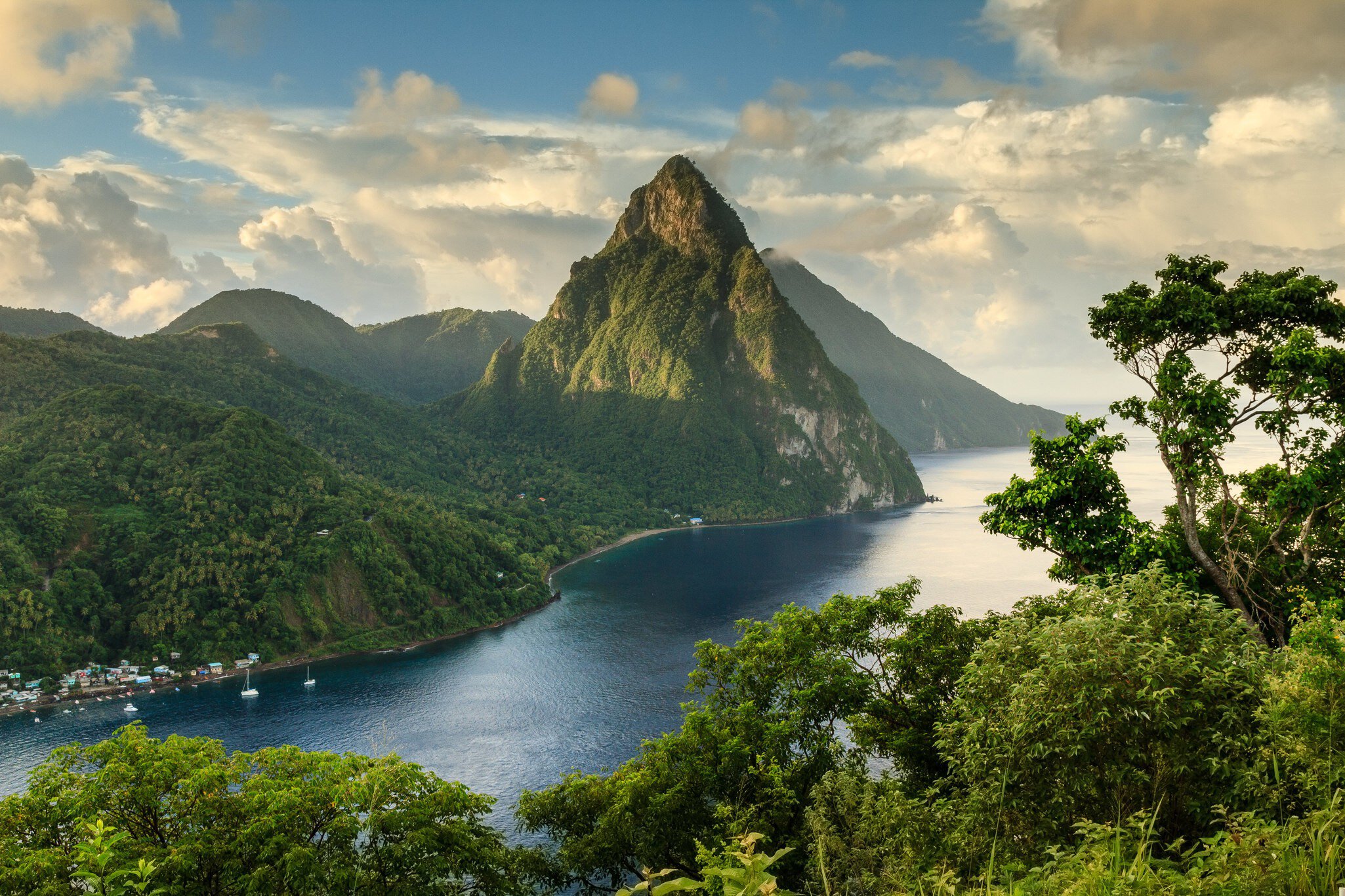 166565984
Bay of Water; Color Image; Outdoors; Rainforest; Reflection; Sunlight; Flickr; No People; Consumerproduct; Day; Horizontal; Photography; Scenics; Tranquility; Mountain Range; Nature; Soufriere; Soufrière; St. Lucia; Standing Water;
View of the Pitons (Petit Piton & Gros Piton) from an elevated viewpoint with the rainforest and bay of Soufrière in the foreground.