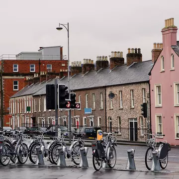 Silver bikes stand at a rack in Belfast waiting to be hired