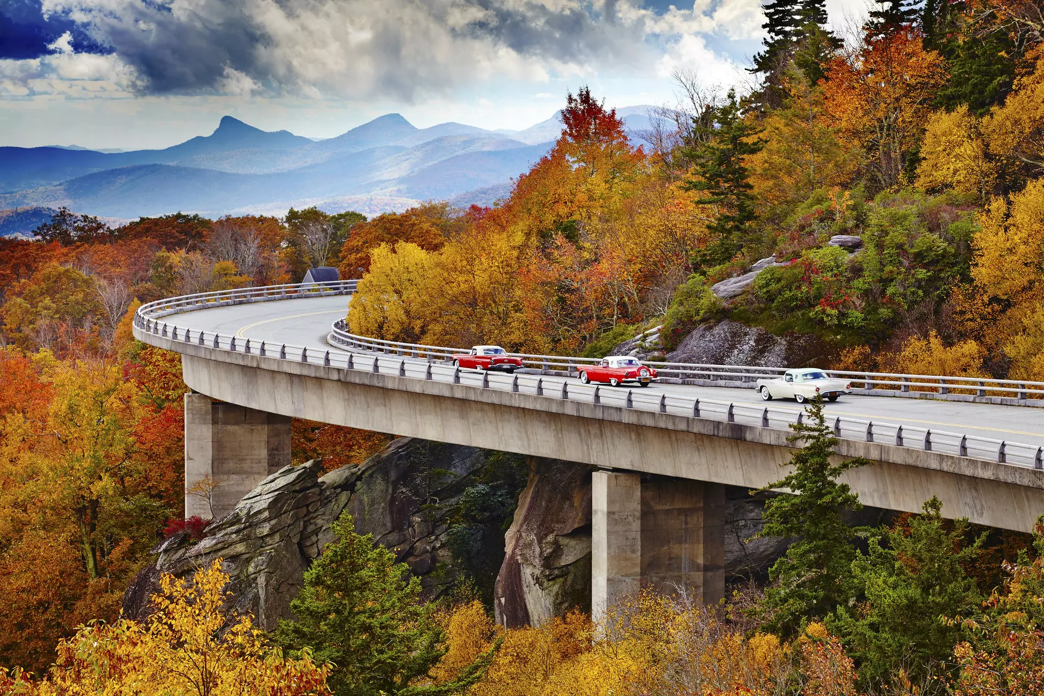 Classic cars on Linn Cove Viaduct in fall, Blue Ridge Parkway Scenic Drive
