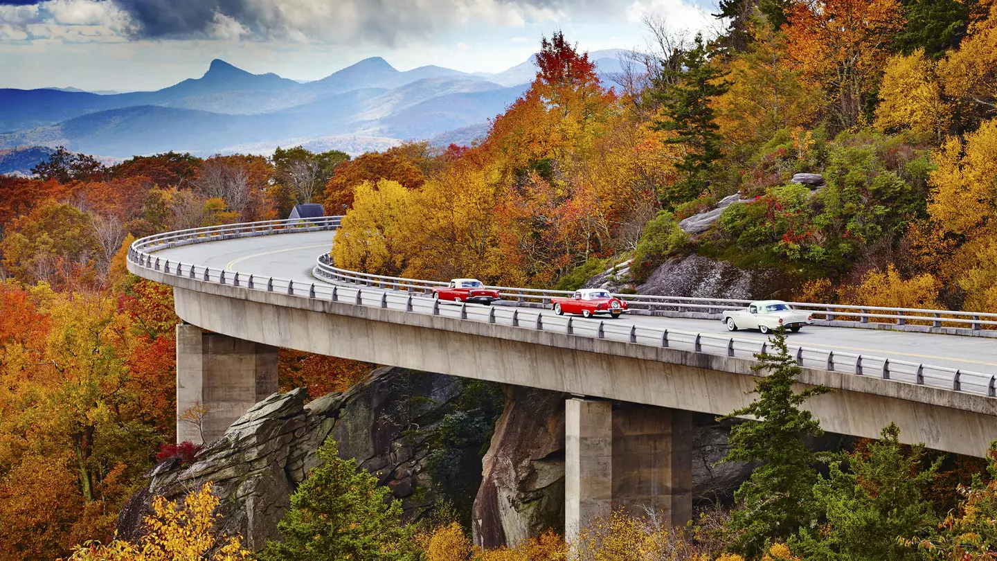 Classic cars on Linn Cove Viaduct in fall, Blue Ridge Parkway Scenic Drive