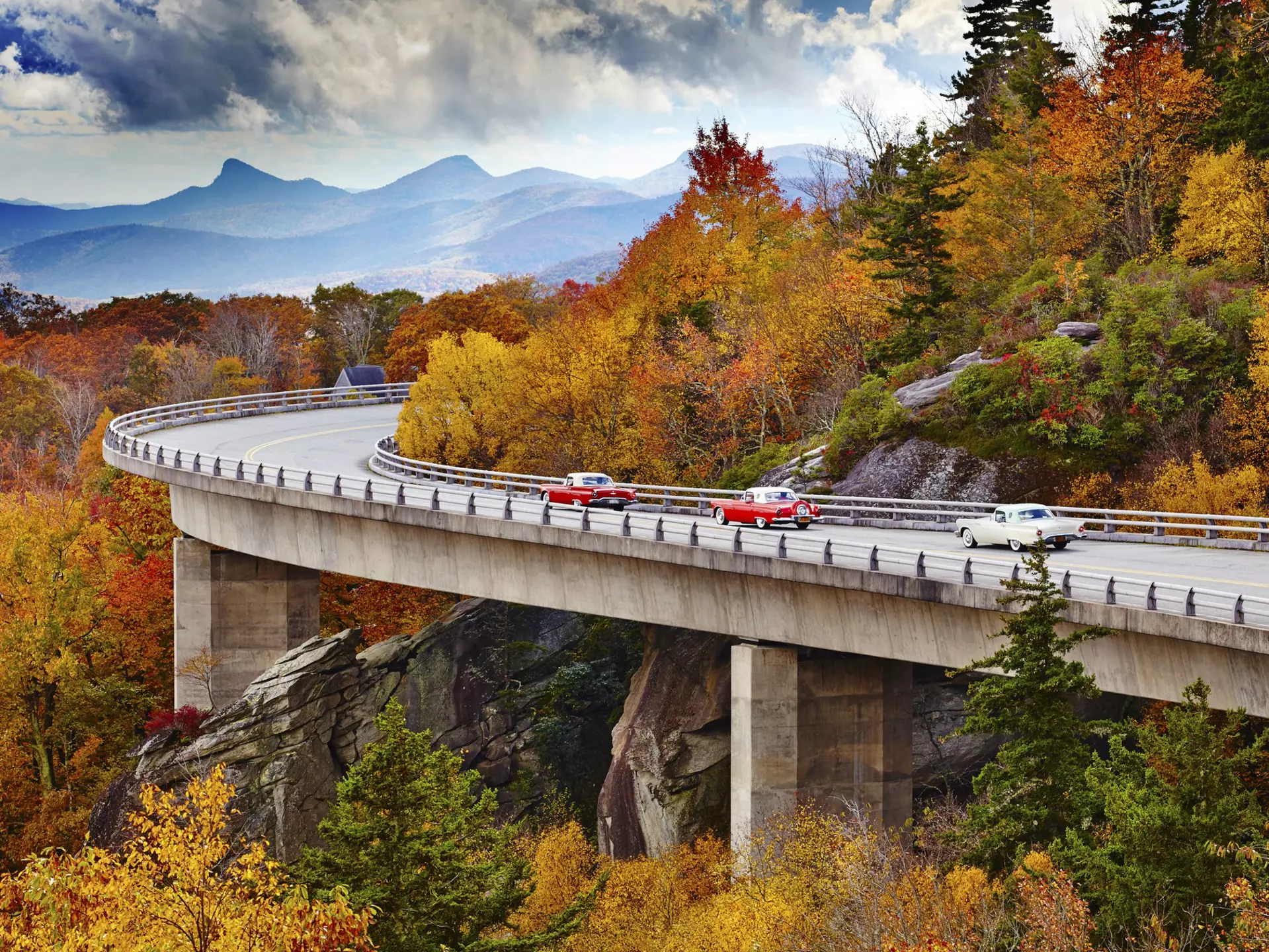 Classic cars on Linn Cove Viaduct in fall, Blue Ridge Parkway Scenic Drive