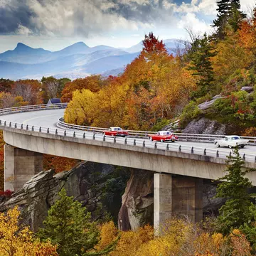 Classic cars on Linn Cove Viaduct in fall, Blue Ridge Parkway Scenic Drive